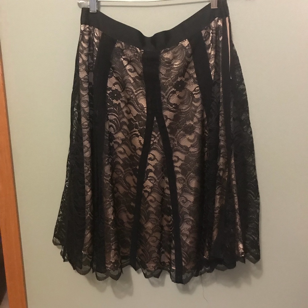 Apostrophe woman’s black lace skirt.
